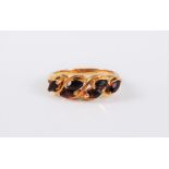 A garnet ring, the the six marquise cut garnets, all claw set to a plain unmarked band (tests as