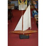 A large lacquered wooden pond yacht with a single mast and full rigging, height 105cm