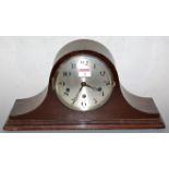 A 1920s mahogany cased mantel clock, having a silvered dial with Arabic numerals, and chiming