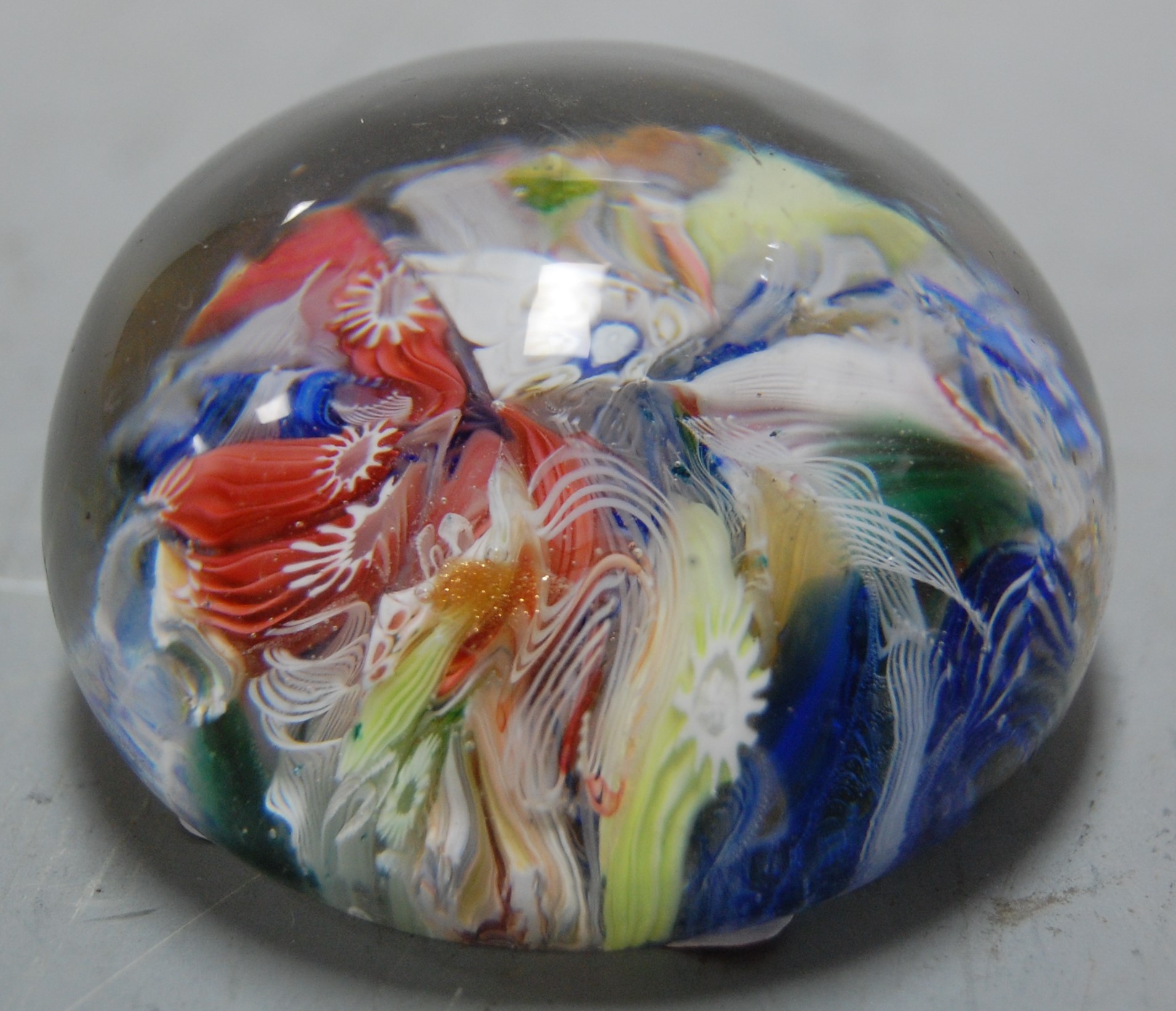 A Baccarat style glass paperweight with multi coloured canes, dia. 5.2cm