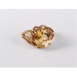 A 9ct gold citrine ring, the oval citrine, claw mounted with tapered tri-furcated shoulders and