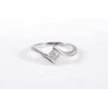 A platinum diamond ring, the four princess cut diamonds, estimated approx. 0.15cts, in a crossover