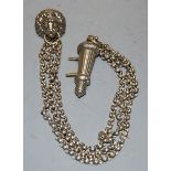 A silver plated whistle, on a belcher link chain with lion mask mount