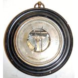 A late Victorian barometer having a silvered dial within ebonised surround, dia. 27cm