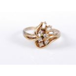 A 9ct gold diamond spray ring, the aysmetric open spray of round and bagette cut diamonds, estimated
