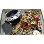 A box of miscellaneous costume jewellery to include rabbit foot brooch, chequered bangle, cufflinks,