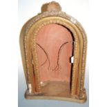 An early 20th century tin and gesso wall niche, h.64cm