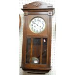 A 1930s oak droptrunk wall clock