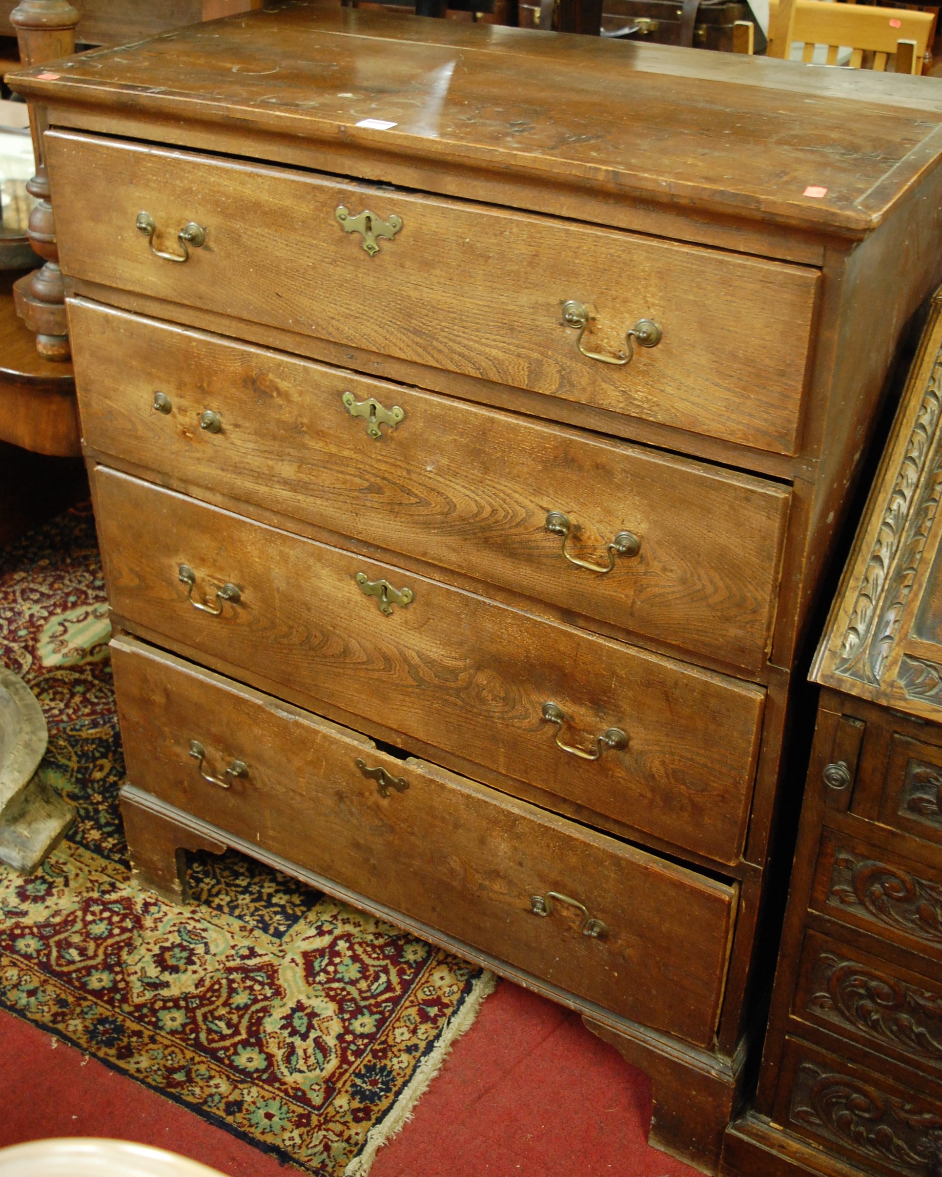 An 18th century provincial oak and elm chest of four long drawers, on bracket supports, w.91.5cm