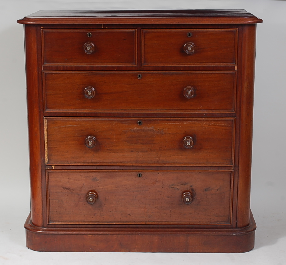 A Victorian mahogany round corner chest, of two short and three long graduated drawers, each