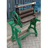 A green painted cast iron freestanding mangle