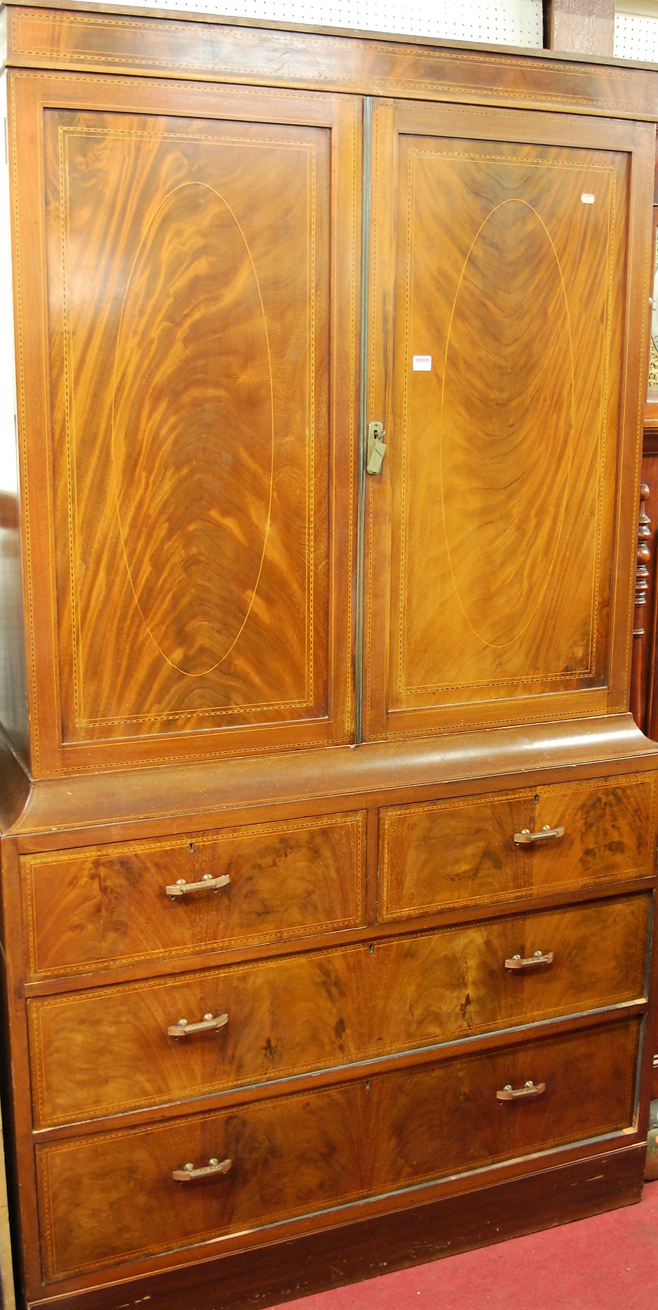 A late Victorian flame mahogany, satinwood inlaid, and chequer strung compactum, the twin upper
