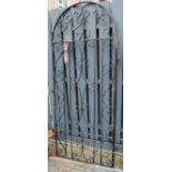 A black painted wrought iron arched single garden gate, with hinged attachement; together with three