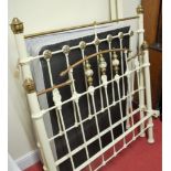 A Victorian cream painted wrought iron and brass three-quarter size bedstead, having folding base