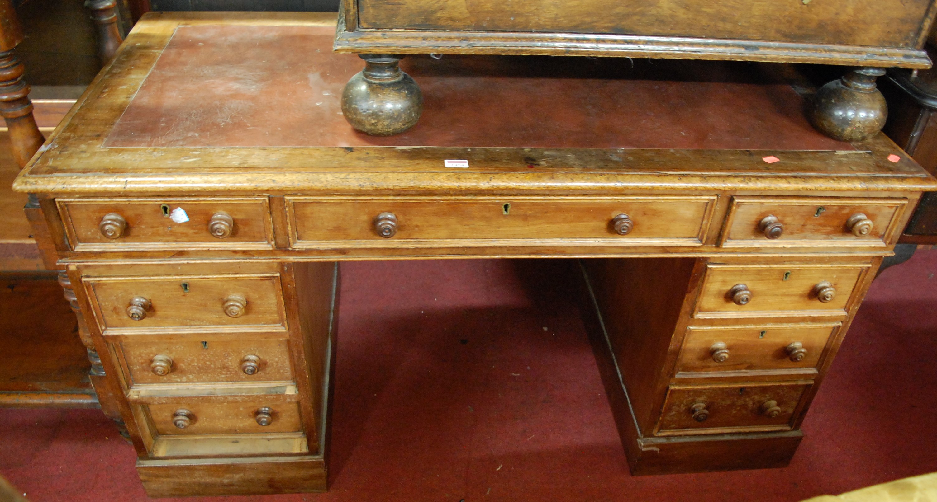 A Victorian faded rosewood? round cornered twin pedestal writing desk, having a replacement rexine