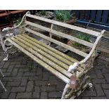 A Victorian style white painted cast metal ended three-seater garden bench, having metal slats, w.