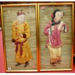 A cased pair of early 20th century Chinese textile puppets, each worked in silk as a male and