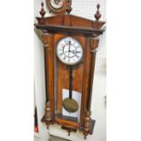 A circa 1900 walnut cased Vienna droptrunk wall clock