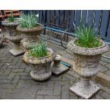 A set of four reconstituted stone campagna garden pedestal urns, h.66cm; together with another
