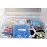 Two plastic boxes containing variety of tools and components from a modeller's workshop, including