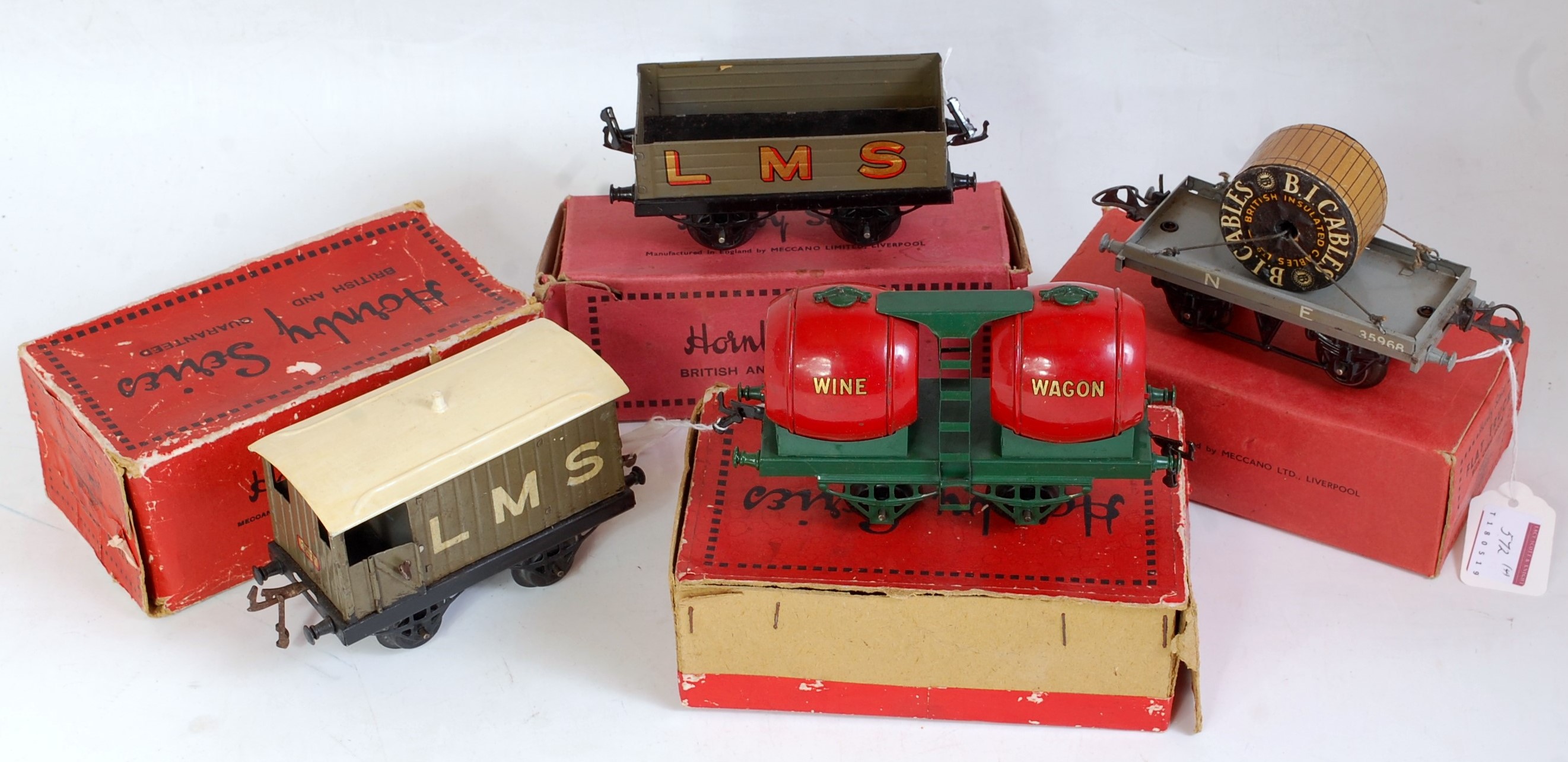 Four boxed pre-war Hornby goods wagons, 1928-30 double wine wagon, green long thin base, red barrels