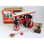 A Mamod TE1 traction engine finished in red with original canopy, steering rod, scuttle, and burner,