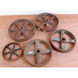 Five various spoked cast iron wheels of various size