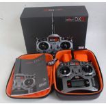 A Spektrum 6 channel 2.4 Ghz DX6I radio controlled aircraft control unit, with the original box in a