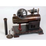An early 20th century tinplate stationary steam engine comprising of tin housed boiler, with