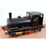 A 5" gauge live steam coal fired 0-4-0 saddle tank locomotive finished in black with removable cab