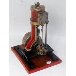 A live steam vertical Stuart Turner type steam engine comprising of a single vertical cylinder