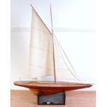 Wooden and plastic hulled sailing yacht, un-powered example, fitted with canvas sails, raised on