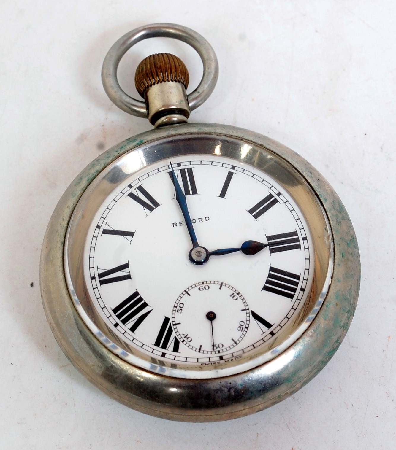 A silver plated open faced pocket watch by Record comprising enamel dial with Roman numerals and