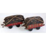 Two Bing open wagons, maroon GN with loads and tarpaulins, one dated 1910 on solebar, other 1912,