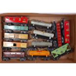 Twelve assorted Lionel bogie goods wagons including 4 tanks, 5 box cars, 2 open and a hopper (G)