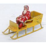 A Morestone Series Father Christmas and Reindeer Sleigh, comprising yellow sleigh with bell