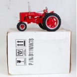 A Franklin Mint 1:12 scale diecast model of a Farmall Model H tractor, comprising red body with