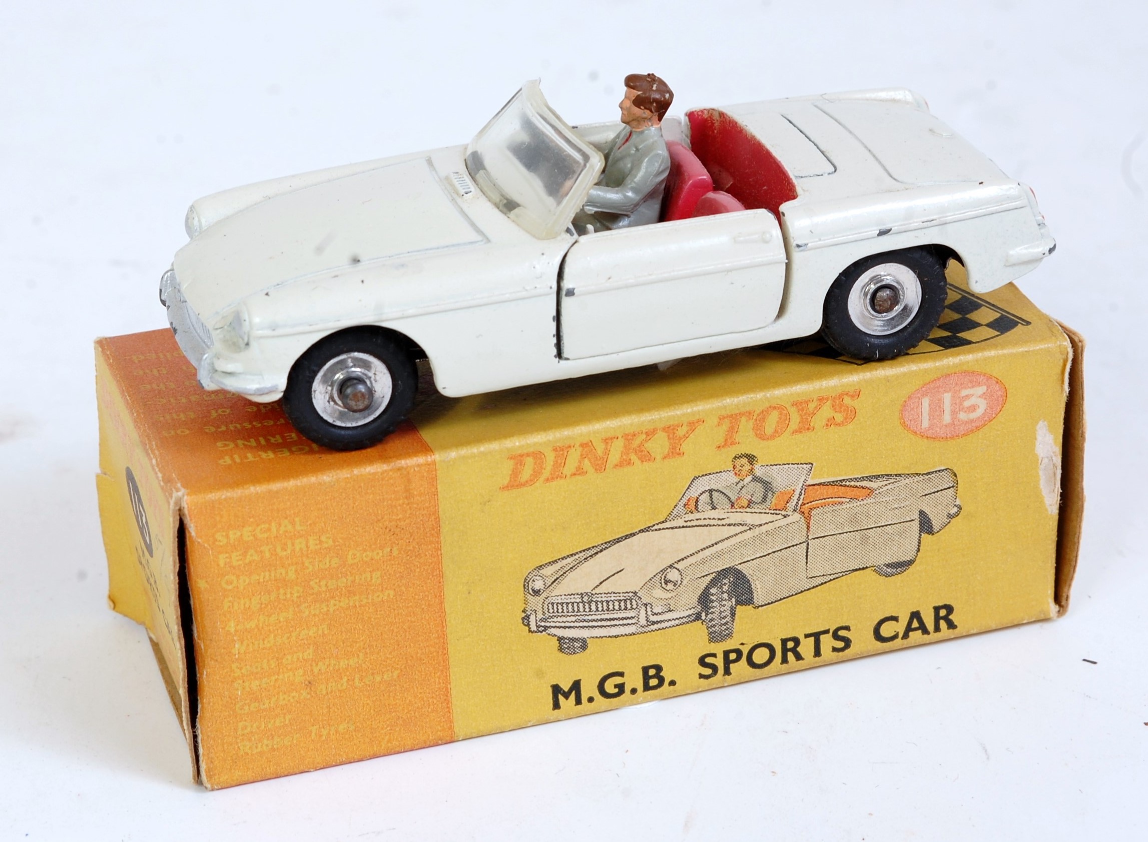 A Dinky Toys No. 113 MGB sports car comprising cream body with red interior and driver figure,
