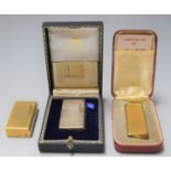 A 1970s Dunhill Rollagas pocket cigarette lighter in a textured gold plated case, and fitted red