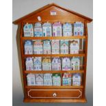 A set of 24 Brooks & Bentley ceramic herb jars and covers, each in the form of a house, in four tier