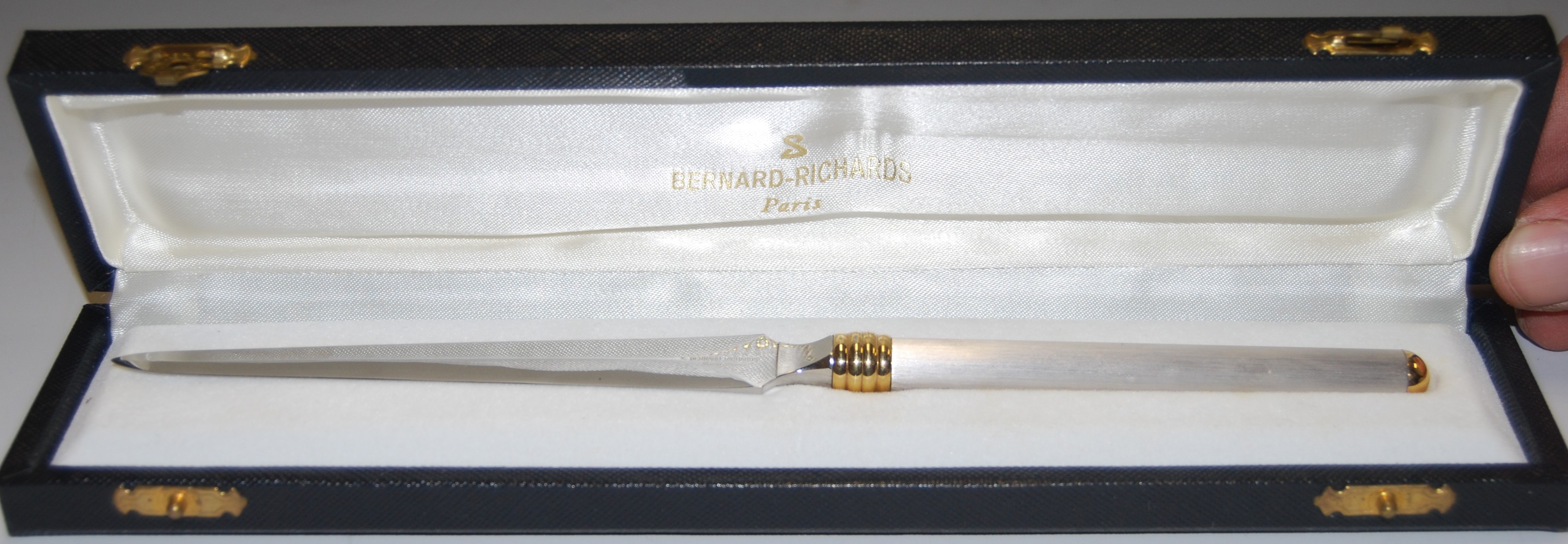 A boxed Inox of France paperknife with white metal and gilded handle, retailed by Bernard-Richards