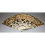 An early 20th century ladies fan having a pierced faux ivory spokes and printed paper ends (A/F)