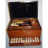 An Edwardian mahogany artists paint-box, the hinged top revealing fitted interior, with further