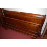 A contemporary French cherrywood kingsize sleigh bed, having side rails and slats