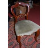 A set of nine Victorian mahogany balloon back serpentine front dining chairs, each having green