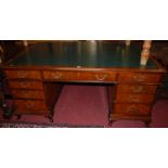 A walnut and figured walnut, gilt tooled green leather inset twin pedestal writing desk, having an