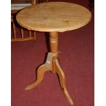 A contemporary pine circular fixed top pedestal tripod occasional table, dia. 52cm