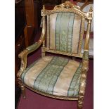 A pair of contemporary French Louis XVI style giltwood fauteuil, each with striped floral upholstery
