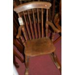 An early 20th century elm seat and beech stickback farmhouse rocking armchair