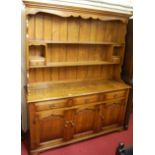 A Georgian style contemporary joined oak Welsh dresser, the base fitted with three frieze over three